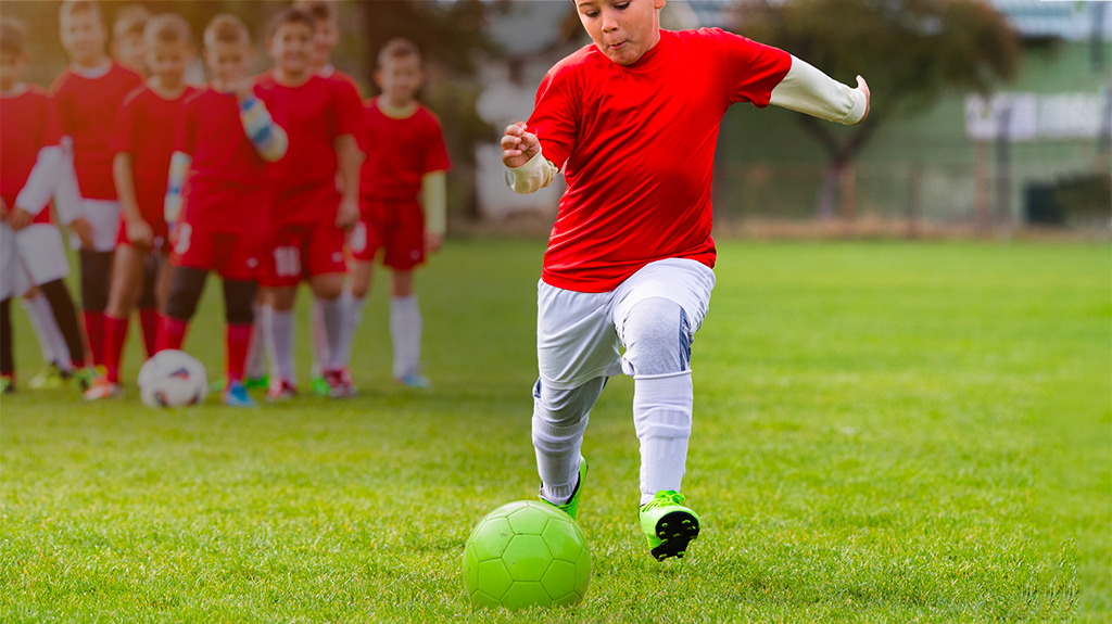 Child kicking a soccer ball